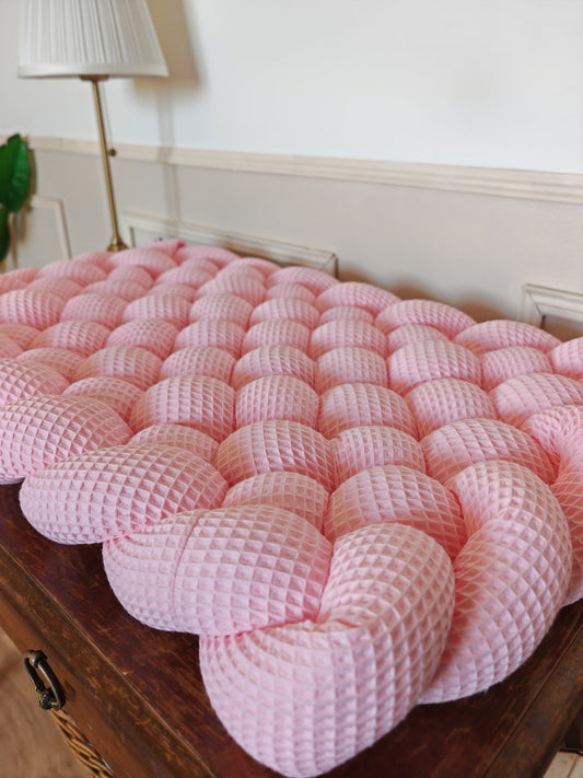 Tapis à langer tressé rose